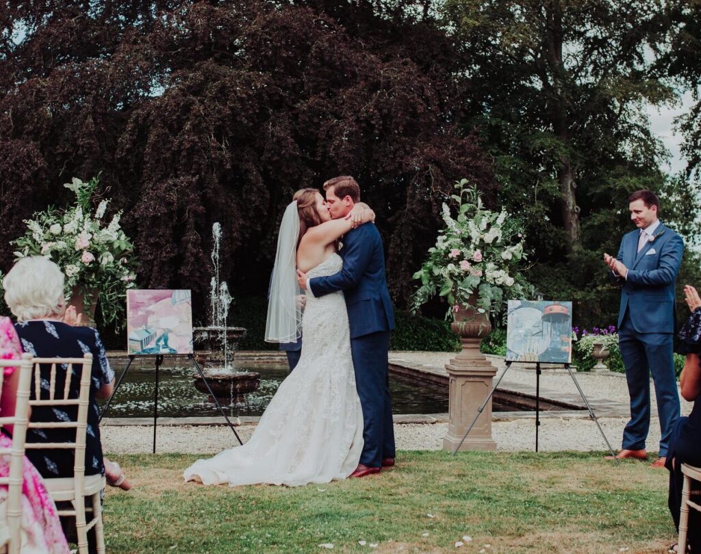 Bride and Groom Kiss during their Symbolic wedding ceremony where they exchange art as part of their vows.