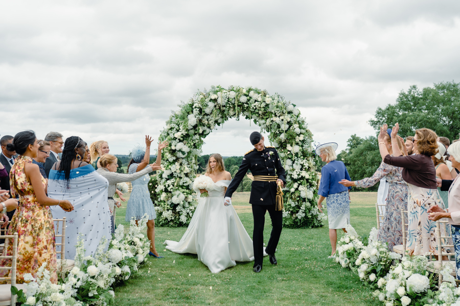 Bride and groom confetti moment exiting wedding ceremony