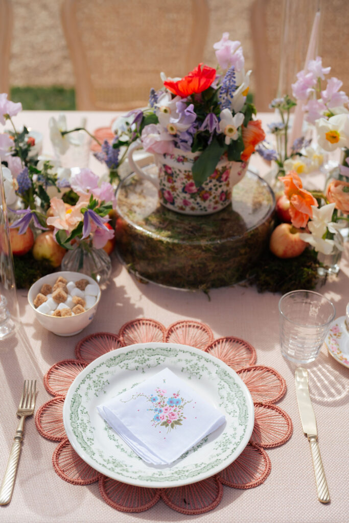 A patterned pastel place setting with  fruit and summer florals for a short notice wedding planned at Four Seasons Hampshire by Ella Hartig