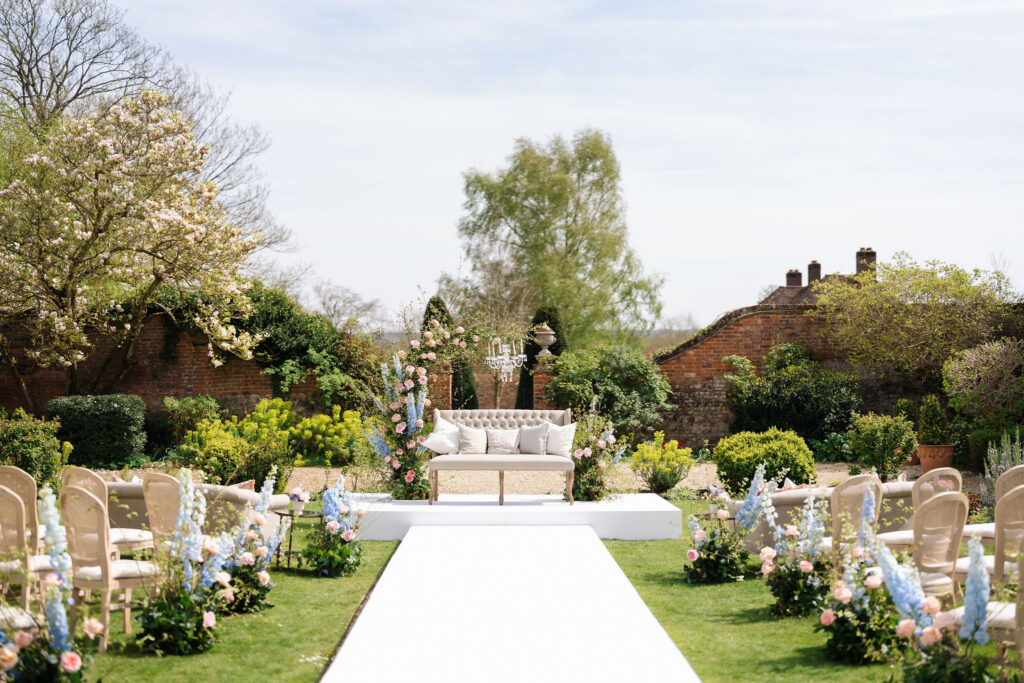 An outdoor wedding ceremony with summer florals for a short notice wedding planned at Four Seasons Hampshire by Ella Hartig