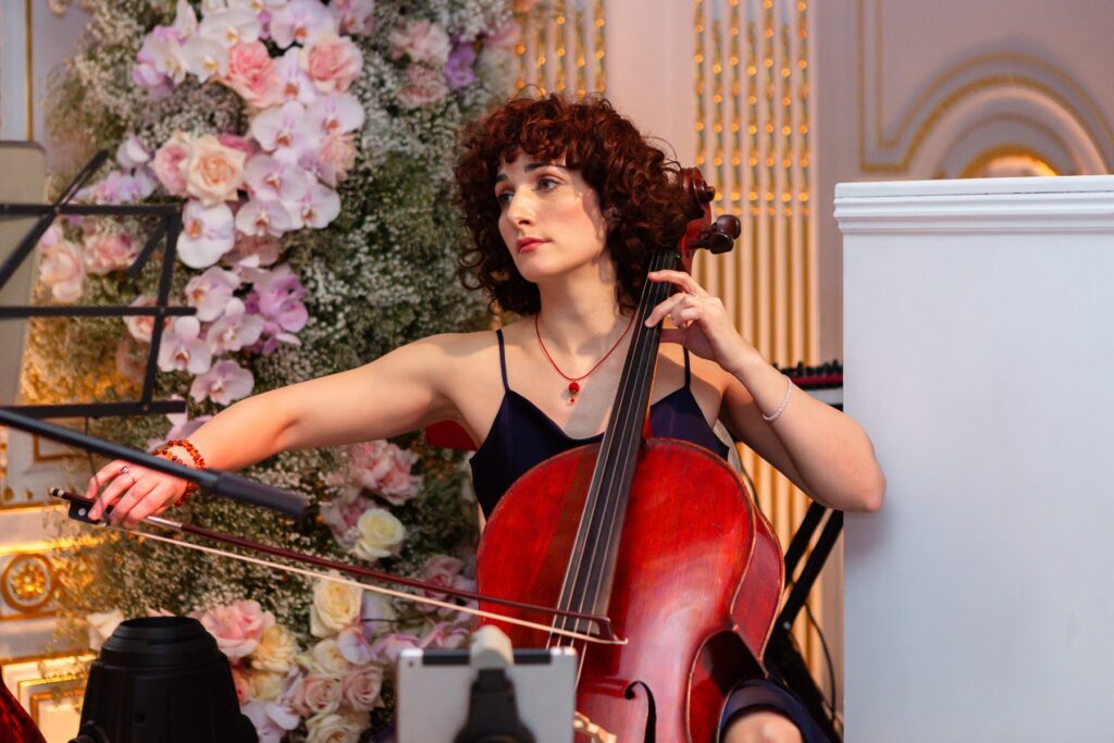A woman playing an instrument, at a short notice wedding planned at Mandarin Oriental by Ella Hartig