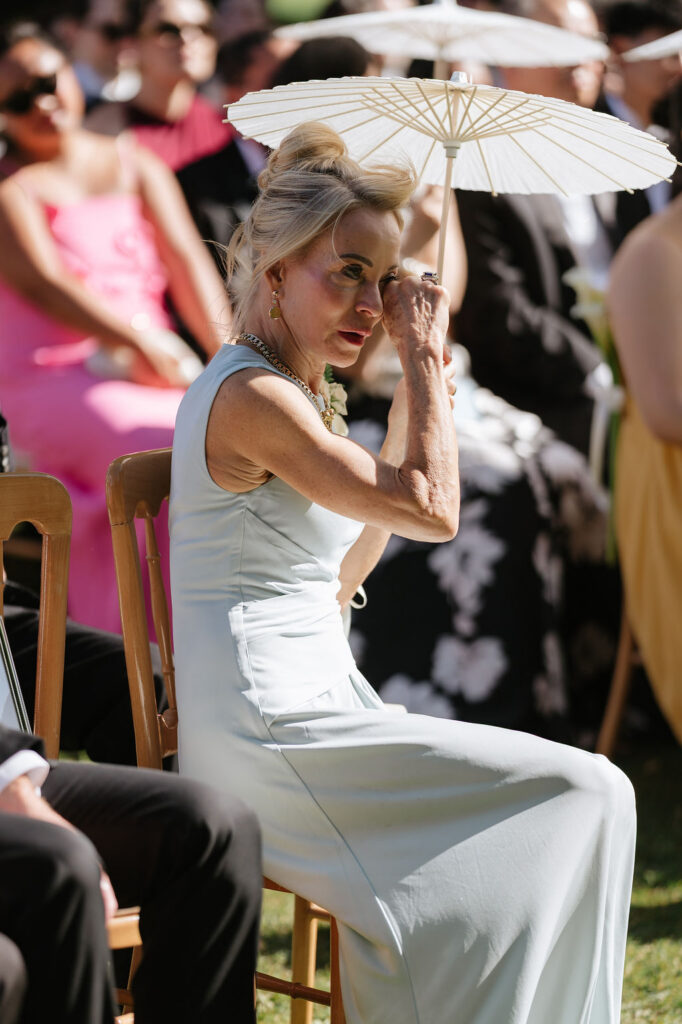 emotional moments in a wedding ceremony, Mother wipes away a tear